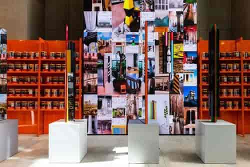 Vibrant exhibition display at 180 Atrium, featuring bold orange backdrop and curated products.