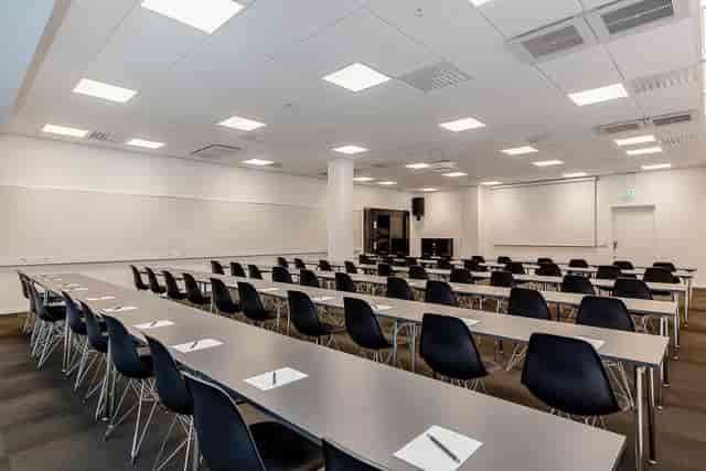 Conference room setup with modern design for workshops and presentations.
