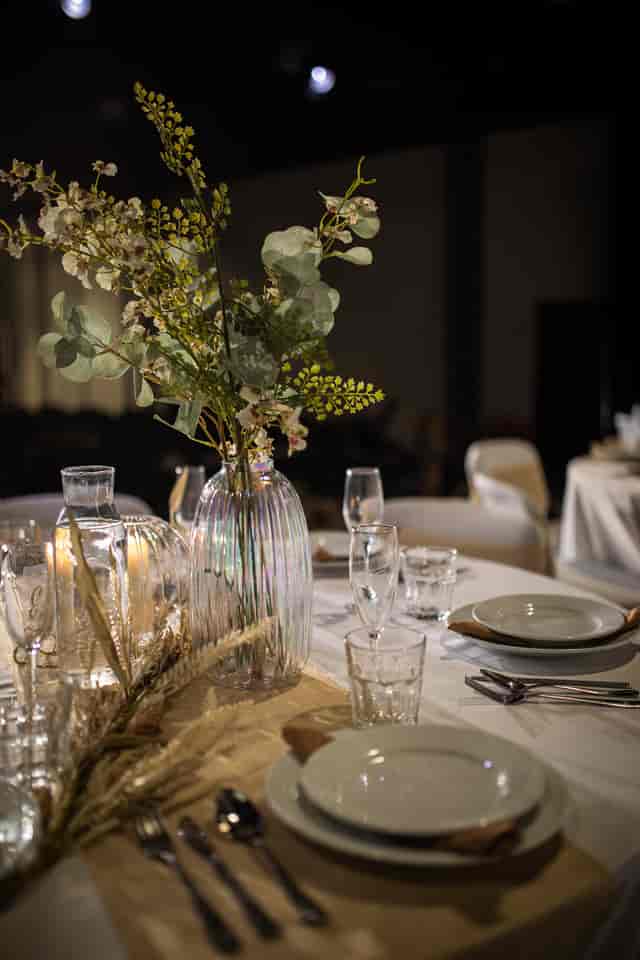 Elegant dining table with flowers in Black Box Theatre for weddings and upscale events.