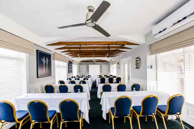 Professional meeting room in Brookhaven, featuring elegant blue chairs and natural light.