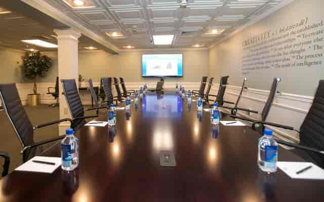 Conference room at The Olde Mill Inn with polished table, ideal for meetings and events.