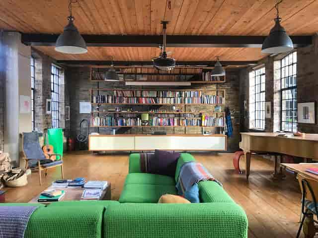 Vibrant Shoreditch event space with cozy sofa, ideal for creative meetings and gatherings.