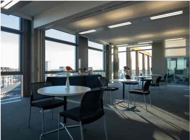 Modern meeting room with large windows, ideal for corporate events and networking.