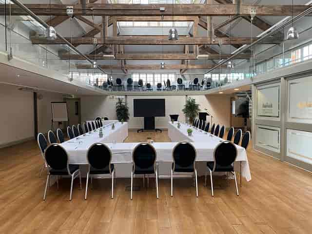 Riding School meeting space with U-shaped table, ideal for corporate events and presentations.