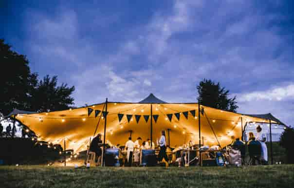 Outdoor event at Hatfield House with illuminated tent, ideal for weddings and retreats.