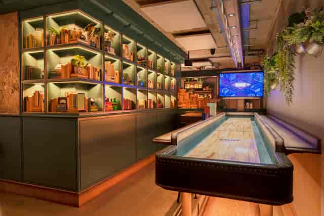 Stylish event space with shuffleboard table at Electric Shuffle Leeds for networking.