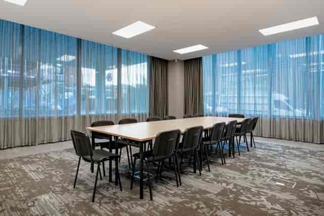 Modern meeting room in AC Hotel Manchester, featuring a large table and natural light.