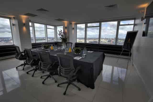 Modern meeting room at Altitude 360 with panoramic city views for corporate events.