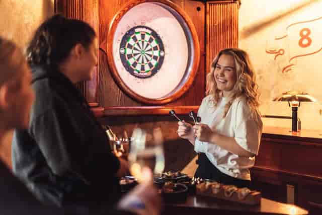 Oche Venue Amsterdam: vibrant networking space with dartboard for team-building events.