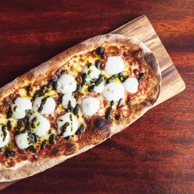 Gourmet flatbread pizza at Oche Venue, ideal for networking events and casual gatherings.