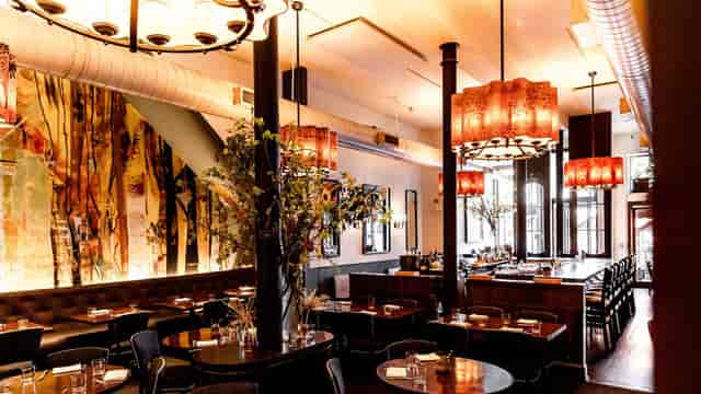 Semi-private restaurant area with warm lighting for intimate gatherings and corporate events.