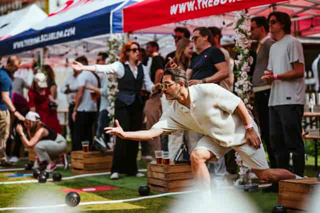 Outdoor team-building event at The Bowls Club, featuring vibrant tents and casual games.