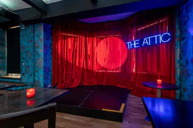 Attic venue in Zebrano Soho with neon sign, perfect for intimate events and gatherings.