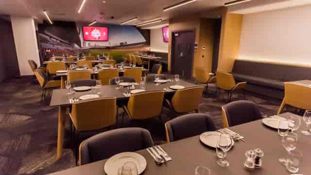 Modern dining setup in The Boardroom, Brentford FC for corporate events and meetings.