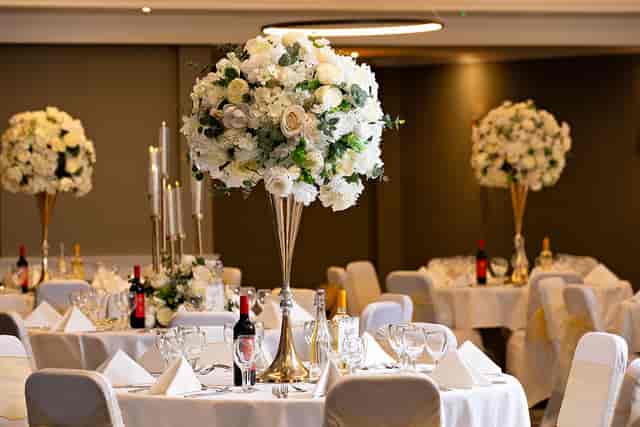 Elegant event space with floral centerpieces, ideal for weddings and gatherings.