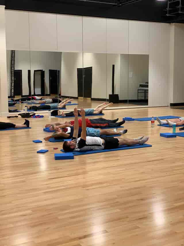 Yoga class in spacious Anchor Point studio, promoting wellness in event planning.