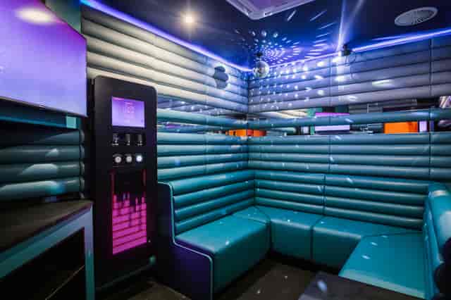 Vibrant karaoke room with sleek seating for team-building and parties at Lucky Voice Liverpool.