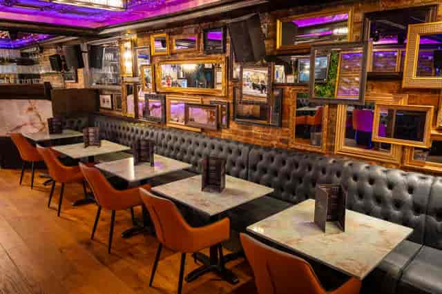 Leather banquette seating at Zebrano Soho: upscale gallery wall space for networking and cocktails.