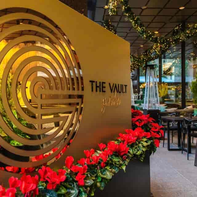 Private dining room entrance at The Vault with elegant signage and floral decor for upscale events.