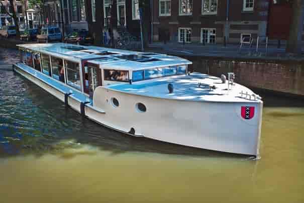 Sleek event boat Monne de Miranda for corporate gatherings on scenic canals.