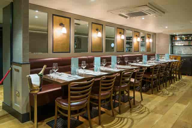 Private dining room at Cote Brasserie, elegant table setup for corporate events and gatherings.
