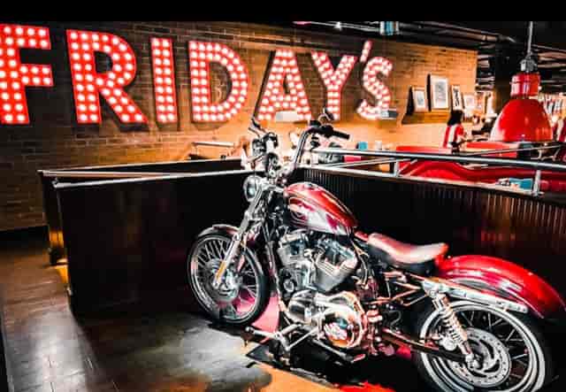 Vibrant restaurant venue with motorcycle display for casual gatherings and themed events.