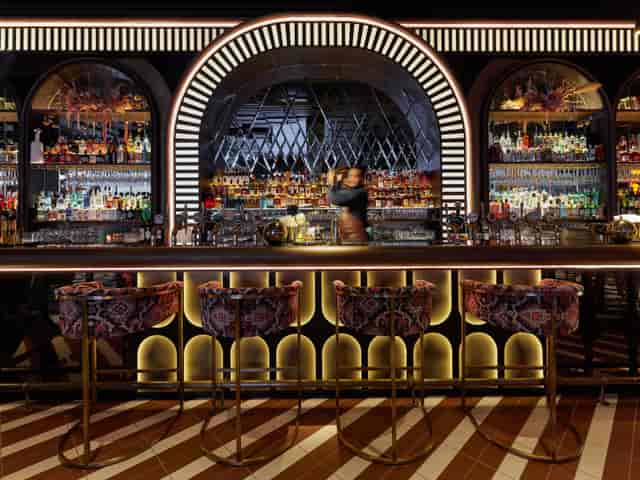 F1 Arcade venue with elegant bar, plush seating for networking events and cocktail receptions.