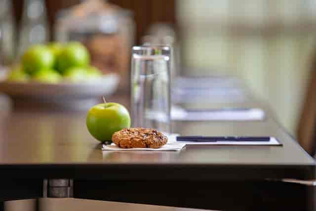 Townshend Suite meeting setup with modern table, green apple, and cookies at DoubleTree Ealing.