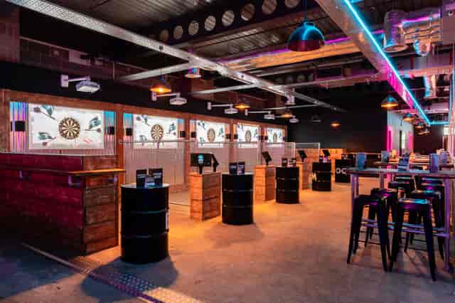 Modern event space with dartboards for private hire, ideal for networking and team-building.