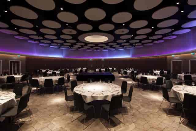 Stephenson Suite at Crown Plaza Newcastle, elegant event space with round tables and purple lighting.