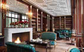 Elegant meeting space with fireplace at La Reserve Paris, ideal for networking events.