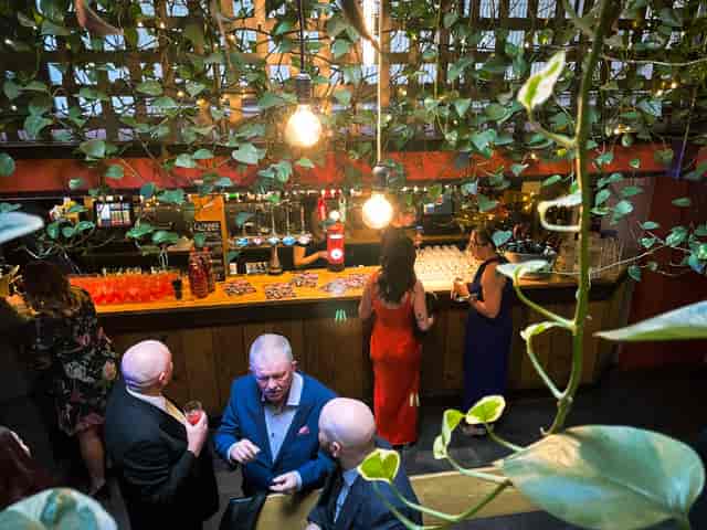 Vibrant Pleasance Theatre bar with guests mingling in a lively event space.
