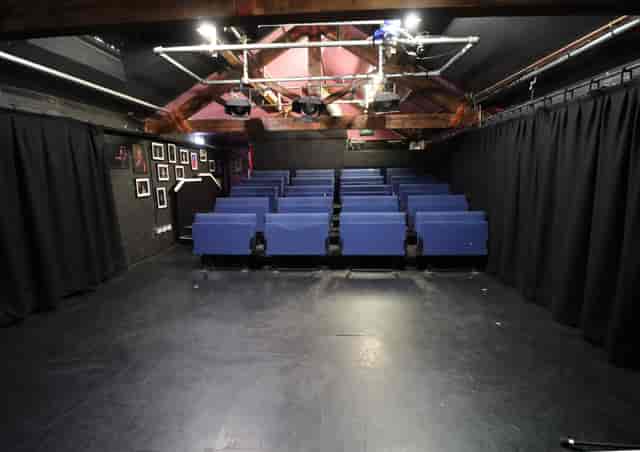 Versatile event space with tiered seating at Pleasance Theatre for workshops and performances.