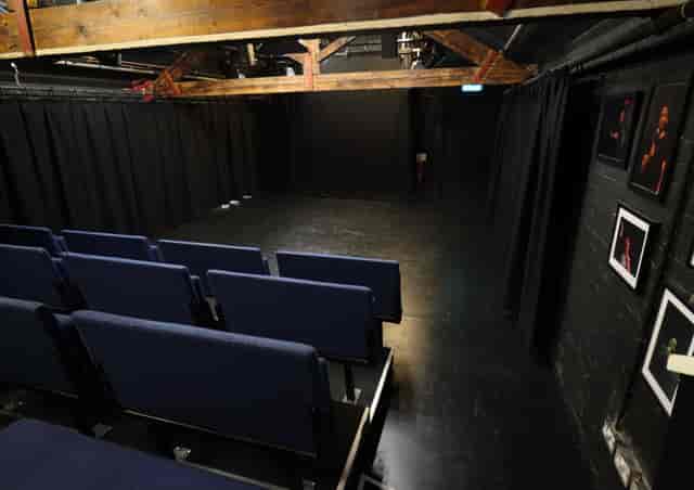 Versatile event space with tiered seating at Pleasance Theatre for workshops and performances.