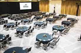 Symphony Ballroom at Hilton Miami: elegant conference space with navy tables and centerpieces.