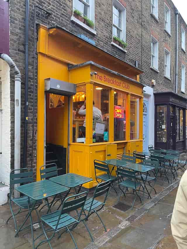 Vibrant yellow café exterior, ideal for brunch meetings and casual networking events.