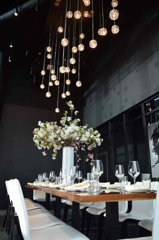 Elegant floral centerpiece in STK Rooftop Stratford's private dining room for upscale events.