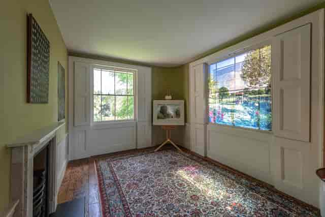 Elegant meeting space in Turner's House with large windows, ideal for gatherings and workshops.