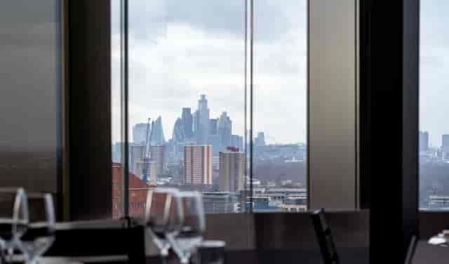 "Upscale event space at STK Rooftop Stratford with urban skyline view and elegant decor."