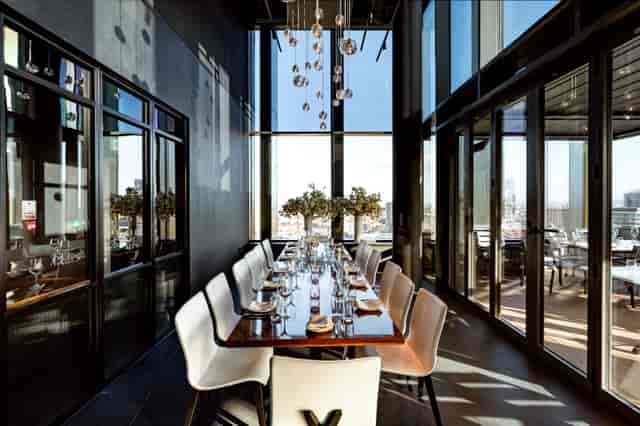 Private dining room with elegant table and views at STK Rooftop Stratford for events.