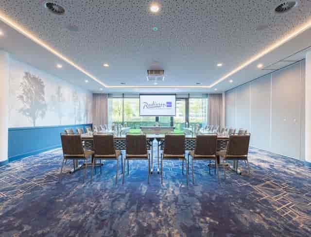 Meeting room at Radisson Blu, Amsterdam Airport, with U-shaped seating for corporate events.