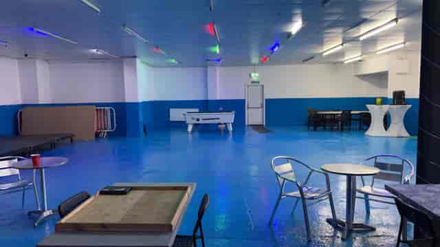 Blue Tick Bar and Grill event space with vibrant blue floor, ideal for parties and gatherings.