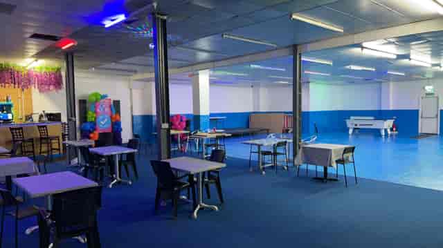 Blue Tick Bar and Grill event space with blue flooring, ideal for meetings and gatherings.
