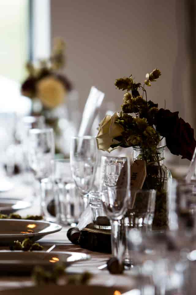 Elegant table setting with floral arrangements at Rising Cafe, Anchor Point for events.