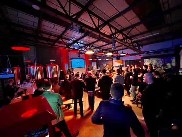 Brewery event space with attendees at a presentation in Halton Turner Brewing Co.