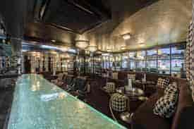 Stylish lounge at The O2, featuring a sleek bar for upscale networking events.