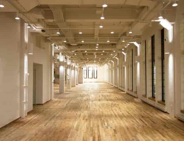 Spacious West Edge venue with polished floors, ideal for conferences and social events.
