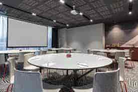 Modern meeting room with round tables for collaboration at Radisson RED, Rosebank.