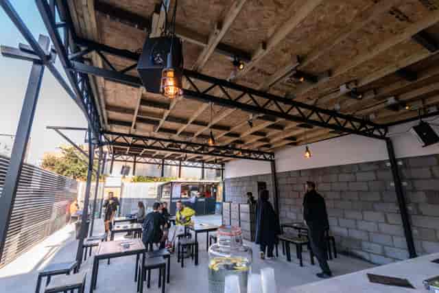 Versatile outdoor event space with modern design, ideal for gatherings and presentations.