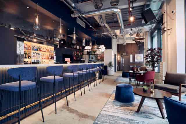 Modern Qube East venue with sleek bar, ideal for meetings and events.